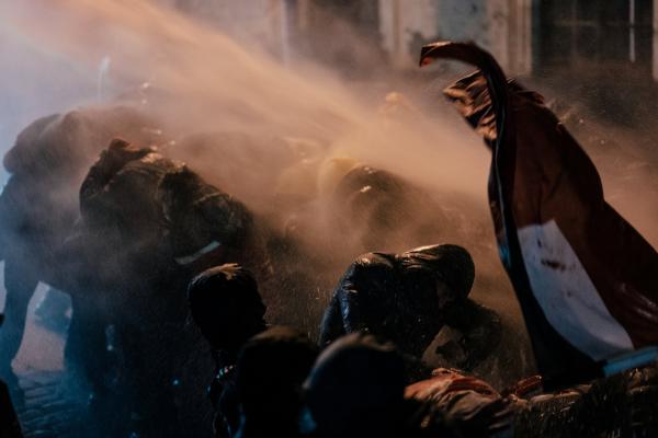 Riot police use water cannons, pepper spray, and tear gas, chasing protesters through the streets an ...
